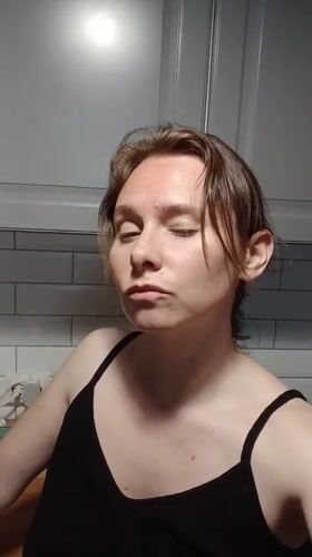 Woman makes facial expressions in Yekaterinburg kitchen setting