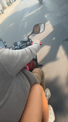 Motorcyclist rides through suburban Đà Nẵng on sunny morning