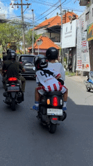 Motorcyclists travel through North Kuta street, Bali Dragon FC rider spotted