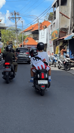 Motorcyclists travel through North Kuta street, Bali Dragon FC rider spotted