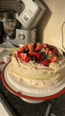 Elaborate pavlova cake documented on turntable in Tel Aviv
