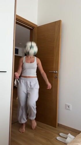Woman juggles soccer ball barefoot indoors in Montenegro bedroom