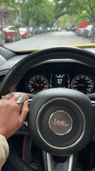 Driver navigates Jeep through Tbilisi street Monday morning