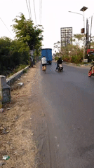 Everyday traffic and street activity along a Sedati road