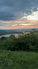 Sunset filmed over river and city from Varna hillside