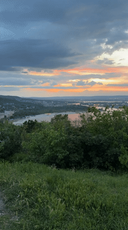 Sunset filmed over river and city from Varna hillside