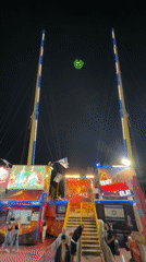 Night fairground slingshot ride operates in Eilat, Israel