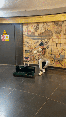 Street musicians perform across Barcelona amid everyday city life