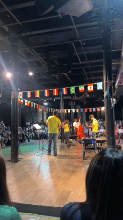 Live band performs under international flags in Puebla venue