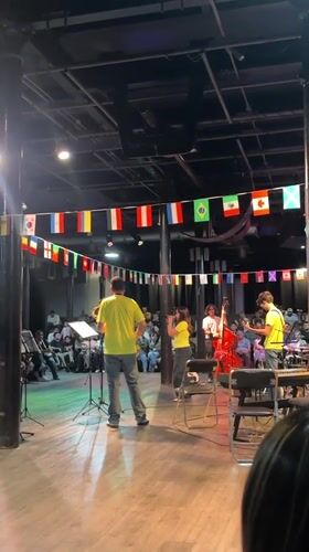 Live band performs under international flags in Puebla venue