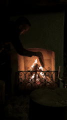 Person tends fireplace in San Lorenzo di Sebato