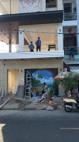 Construction worker paints tropical mural in Nha Trang