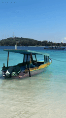 Passenger boat moored in Indonesian turquoise waters near island