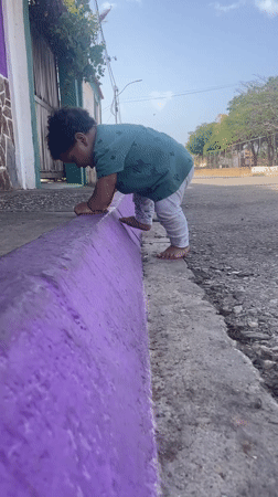 Toddler plays outdoors in Altagracia amid domestic Venezuelan scenes