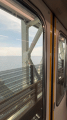 Train passenger films cable bridge view in Izumisano Japan