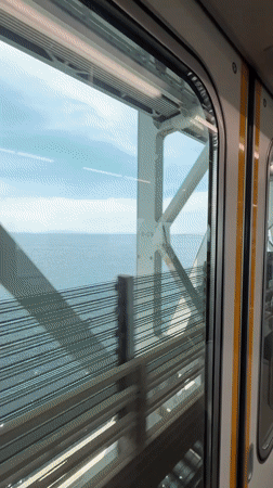 Train passenger films cable bridge view in Izumisano Japan