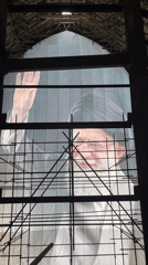 Large portrait with raised hand on display in Tehran