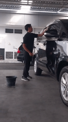 Car wash and street scene outside a modern building in Sleman
