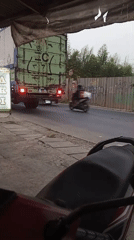 Trucks, motorcycles, and a lit street sign in Setu