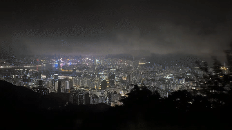 Hong Kong cityscape observed from height under cloudy night sky
