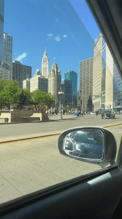 Driver documents routine downtown Chicago traffic and pedestrians