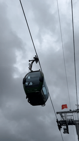 Cable cars operate through overcast Da Lat morning