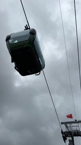 Cable cars operate through overcast Da Lat morning