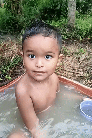 Outdoor bath in a tarp tub, rural Indonesia
