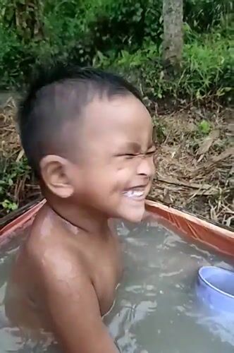 Outdoor bath in a tarp tub, rural Indonesia