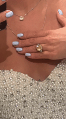 Woman takes selfie wearing pearls and diamonds in Moscow