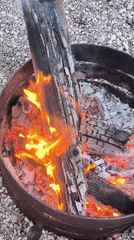 Woman enjoys outdoor fire pit gathering in Lilaste