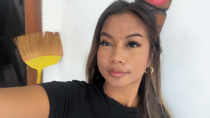 Woman records selfie videos indoors in Sukawati, Indonesia