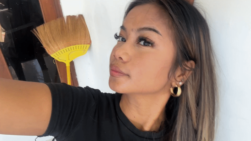 Woman records selfie videos indoors in Sukawati, Indonesia