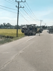Combine harvester stranded on roadside near Indonesian rice paddies