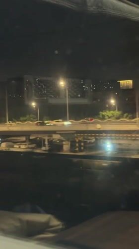 Nighttime traffic scene captured from vehicle in Beijing district