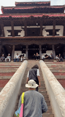 Daily life documented around traditional pagoda architecture in Kathmandu