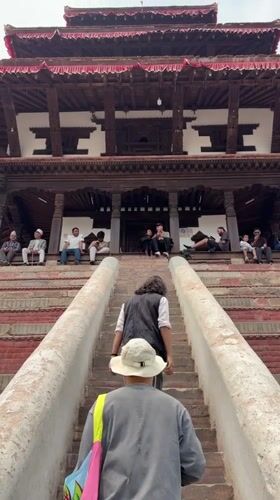 Daily life documented around traditional pagoda architecture in Kathmandu
