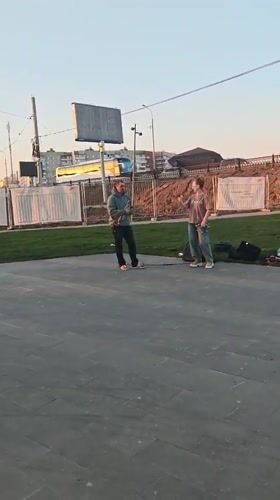 Street musician performs near cathedral in Noginsk, Russia
