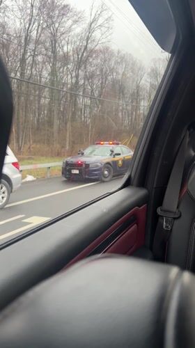 Police car with flashing lights stops Mercedes on roadside