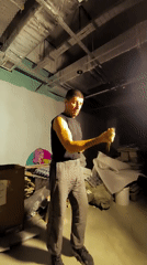 Nunchuck practice in a dim industrial space, Karaganda