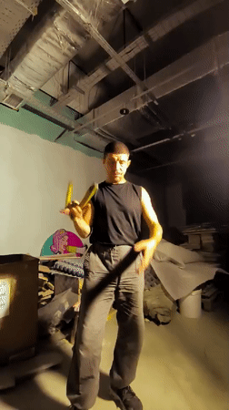 Nunchuck practice in a dim industrial space, Karaganda