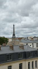 Tourist documents cloudy Paris morning from elevated viewpoint