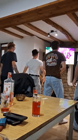Friends play dance video game at home gathering