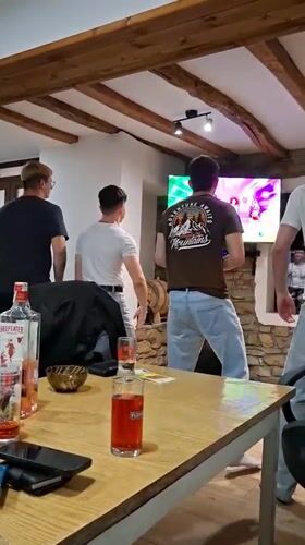 Friends play dance video game at home gathering