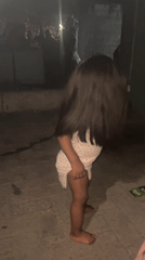 Toddler plays outdoors at night in Ado, Nigeria