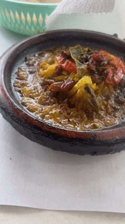 Traditional tagine meal enjoyed at outdoor Boufakrane restaurant