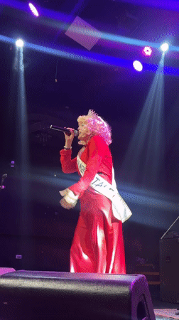 Drag performer takes the stage in Barranco, red gown and crown