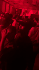 Late-night club scene in Abuja, red lights and a full dance floor