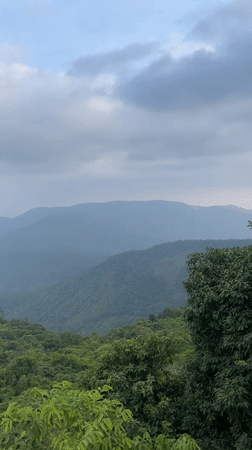 Tourists view scenic mountain landscapes in Chorla, India