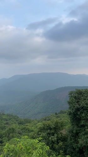 Tourists view scenic mountain landscapes in Chorla, India